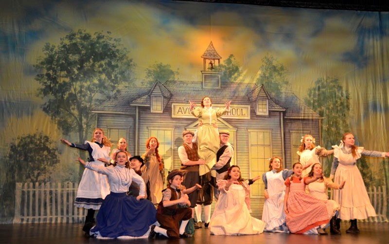 The new schoolteacher Miss Stacey and Avonlea&#8217;s pupils sing Open the Window in Festival Players&#8217; production of Anne of Green Gables now playing at Festival Place