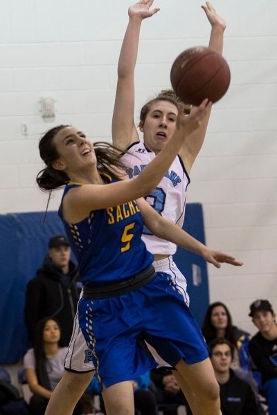 BALL HANDLING â€“ Abby Morrison of the St. Albert Skyhawks makes a play while guarded by Allie Hunder of the Paul Kane Blues in Monday&#8217;s metro Edmonton division one