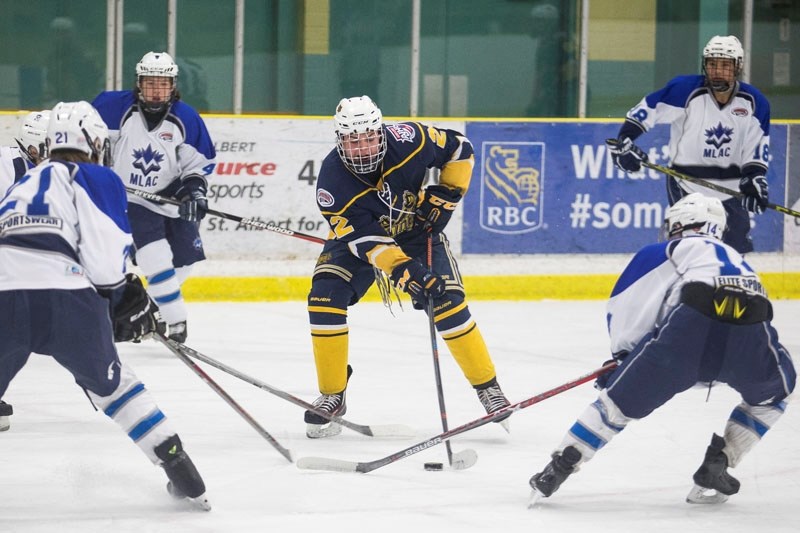 ENCIRCLED â€“ Justin MacDonald of the St. Albert Flyers is surrounded on all sides during a recent Alberta Minor Midget AAA Hockey League game against the Maple Leafs at