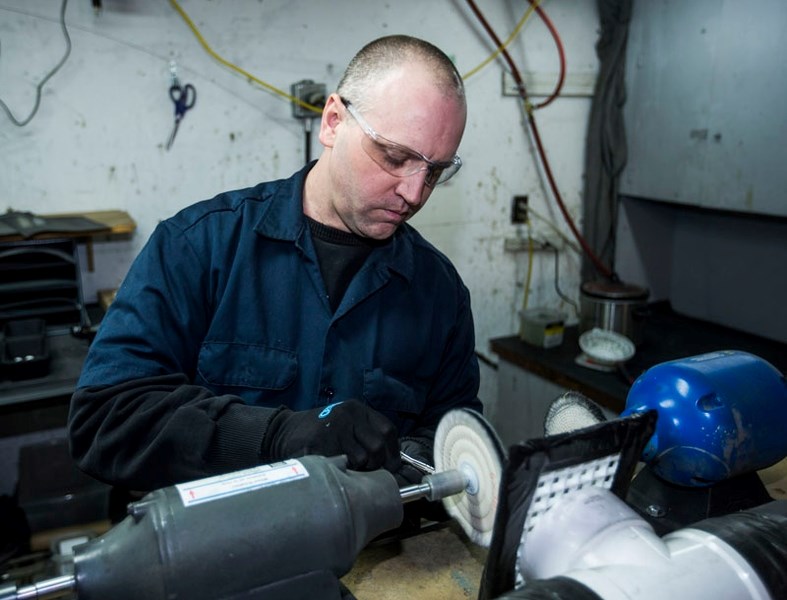 POLISHED FINISH – James Dufour polishes one of his machined safety razors