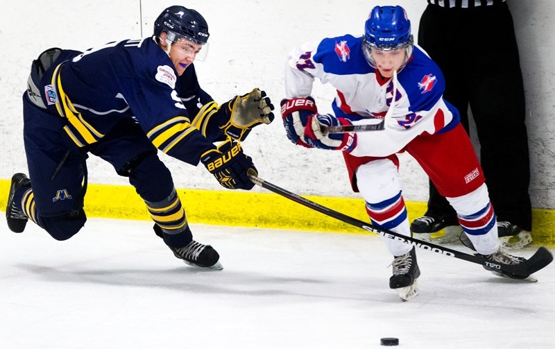 CHECKER – Liam Mowatt of the St. Albert Merchants pressures the puck carrier during junior B action against the Stony Plain Flyers at Akinsdale Arena. Sunday the Merchants