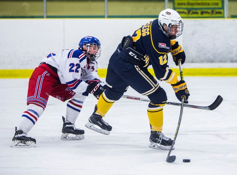 SNIPER – Garrett Clegg of the St. Albert Tire Warehouse Raiders prepares to snap the puck towards the net while pressured by Cayden Shmyr of the Calgary Buffaloes. The