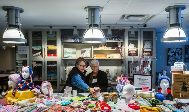ROOM TO IMPROVE? – Volunteers work beneath efficient LED lighting at Red Willow Place in St. Albert. The province announced a $1 million fund last week meant to help groups