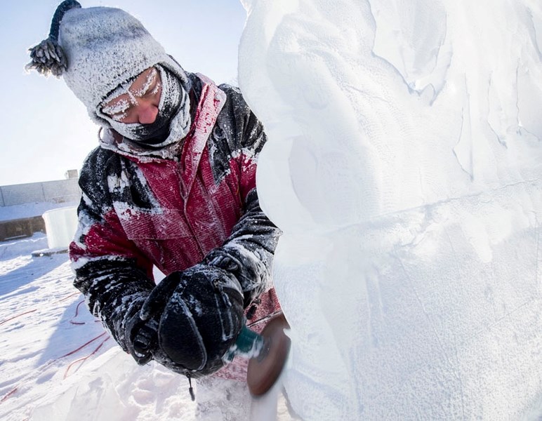 Chainsaw artist Kelly Davies works on an ice sculpture ahead of the 10th annual Deep Freeze Festival along 118 Ave.