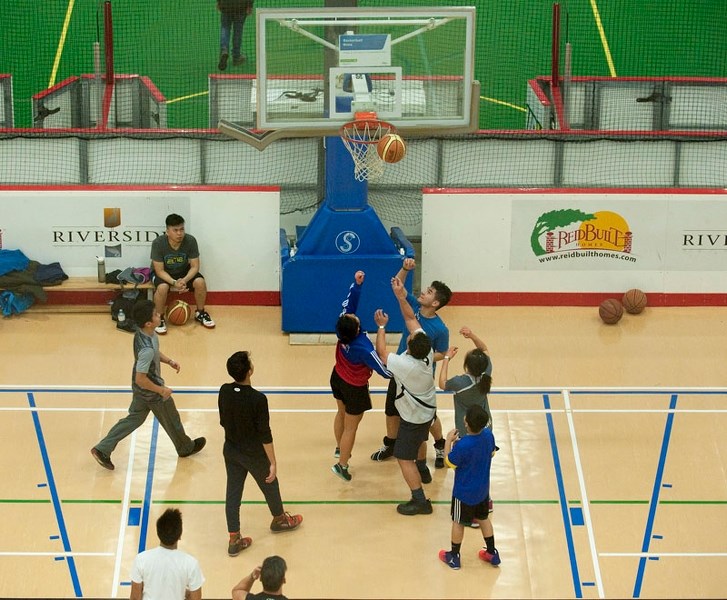 A group of youths face off in basketball action at Servus Place in St. Albert reently. Team sports can be a great way to get fit