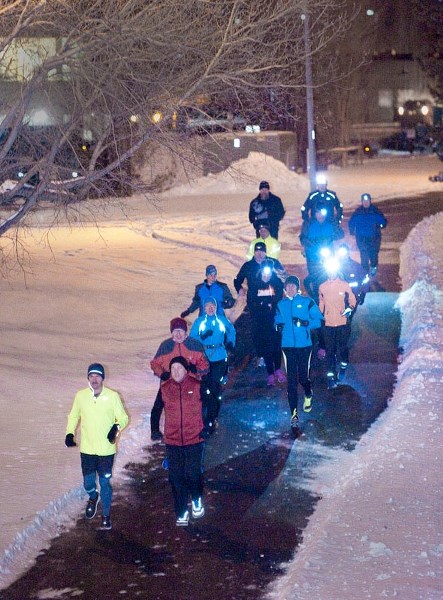 A group of running club members start a run together along the Sturgeon River in St. Albert December 28