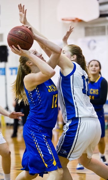FOCUSED â€“ Kaya Vandermeer of the St. Albert Skyhawks aims for the basket while pressured by Gracie Boser of the Catholic Central Cougars of Lethbridge in Saturday&#8217;s