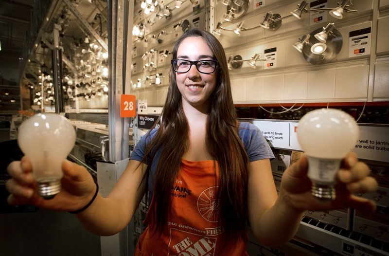 BRIGHT IDEAS – Home Depot employee Caitlin Iseke shows off an incandescent and an LED bulb in this 2015 photo. A new provincial program launching this year will provide