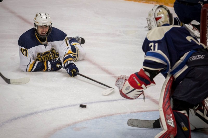 DOWN BUT NOT OUT â€“ Adam Girard of the St. Albert Blues makes a sprawling attempt at the puck against the Maple Leafs during action in the Northern Alberta Midget AA Hockey
