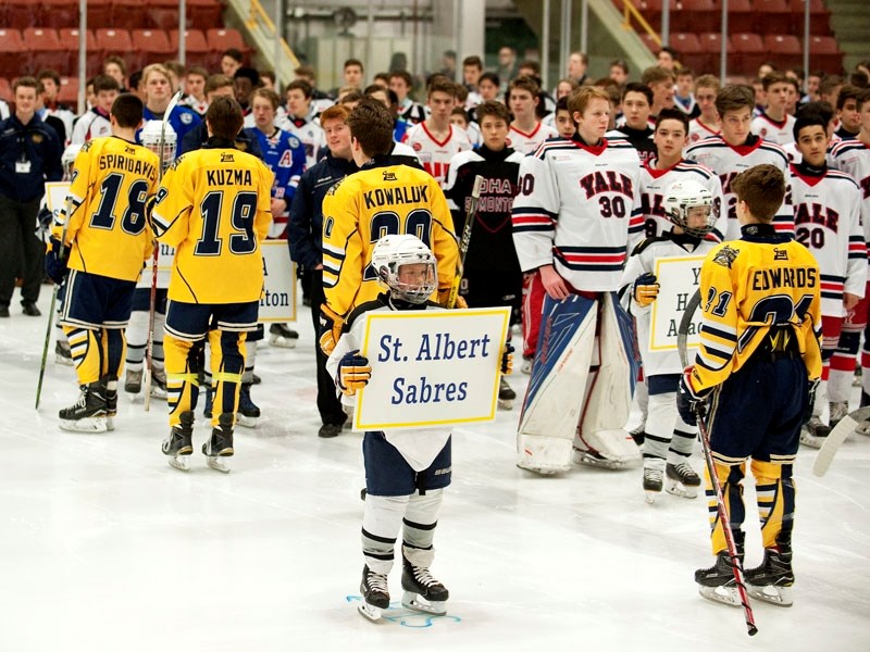 MAKING AN ENTRANCE – The St. Albert Gregg Distributors Sabres join participating teams at Thursday&#8217;s opening ceremonies for the John Reid Memorial Tournament at Go Auto 