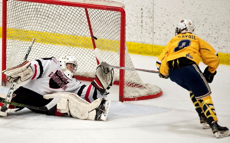 FILLING THE NET – Carter Savoie of the St. Albert Gregg Distributors Sabres snipes a goal against Liam Tereposky of the Okanagan Hockey Academy of Edmonton to open the