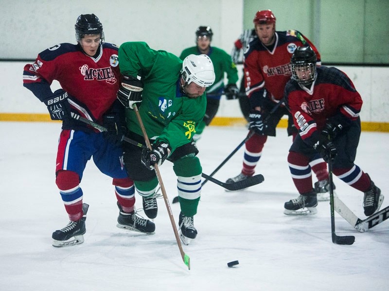 FAMILY BRAGGING RIGHTS â€“ Cole Granger of the SheeFitz (Sheehan and Fitzgerald) team plays the puck while checked by Zach McRae of the McKief (McRae and Kieftenbeld) team