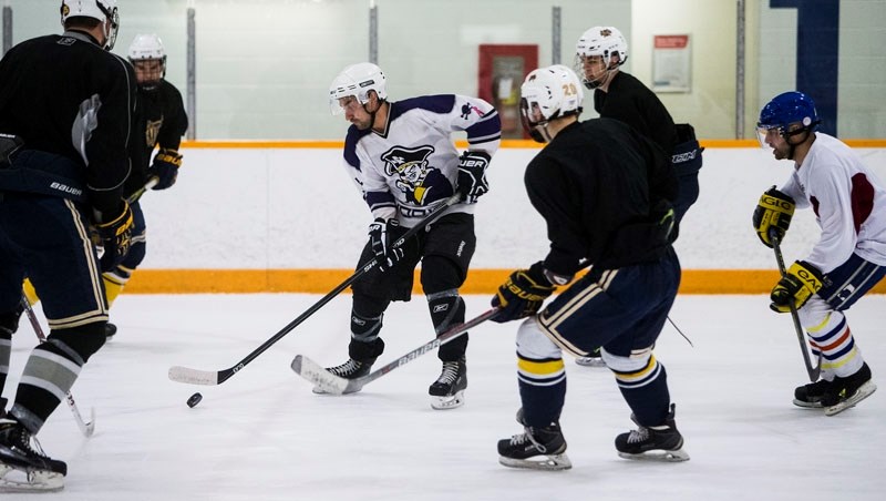TEACHING THE STUDENTS â€“ The inaugural Bellerose staff versus student charity hockey game last Friday at Mark Messier Arena raised $310 and lots of donated items for the St. 