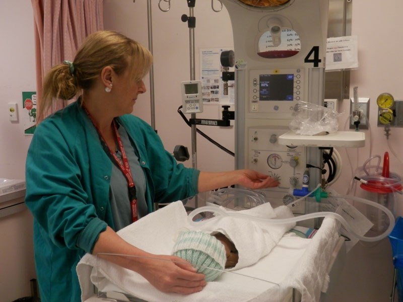 A neo-natal nurse practitioner at the Sturgeon Community Hospital helps a newborn with a PANDA unit. The transport unit helps all of the hospital&#8217;s estimated 3