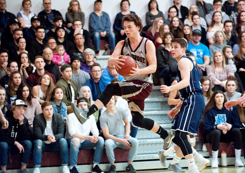 WALKING ON AIR – Tye Weiss of the Bellerose Bulldogs springs into action in front of the Paul Kane Blues&#8217; fans and Logan Buchanan of the Blues in Monday&#8217;s metro