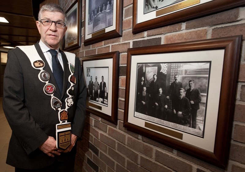CHAINS OF HISTORY – Mayor Nolan Crouse wears the chain of office at city hall. To the right is a photo of St. Albert&#8217;s first council and mayor