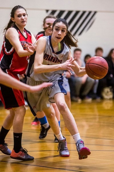 ATTACKER &#8211; Zoe Zurowski of the Vincent J. Maloney Marauders pushes the ball past Sarah McClelland of the Sir George Simpson Voyageurs in the St. Albert Physical