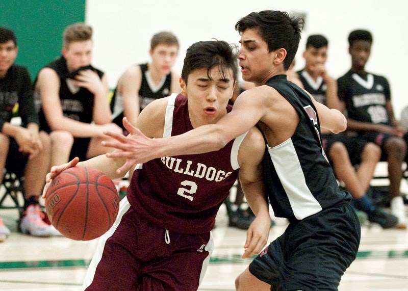 DRVING FORCE â€“ Sajad Karimi of the Bellerose Bulldogs busts through the defensive coverage of Guryodh Brar in Saturday&#8217;s metro Edmonton division two junior
