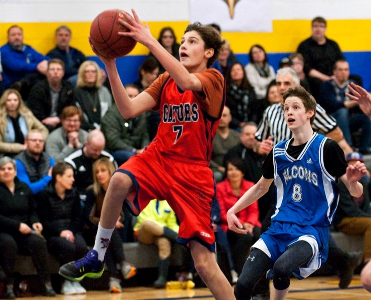 HOOPING IT UP – Roka Phalen-Baker of the Lorne Akins Gators goes for the layup in front of Luke Brodeur of the Richard S. Fowler Falcons in the St. Albert Physical Education