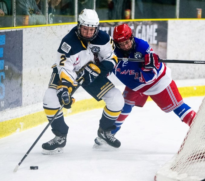 BEHIND THE NET â€“ Tye Pedersen of the St. Albert Gregg Distributors Sabres is pressed to move the puck in Tuesday&#8217;s playoff tilt against the Fort Saskatchewan Rangers