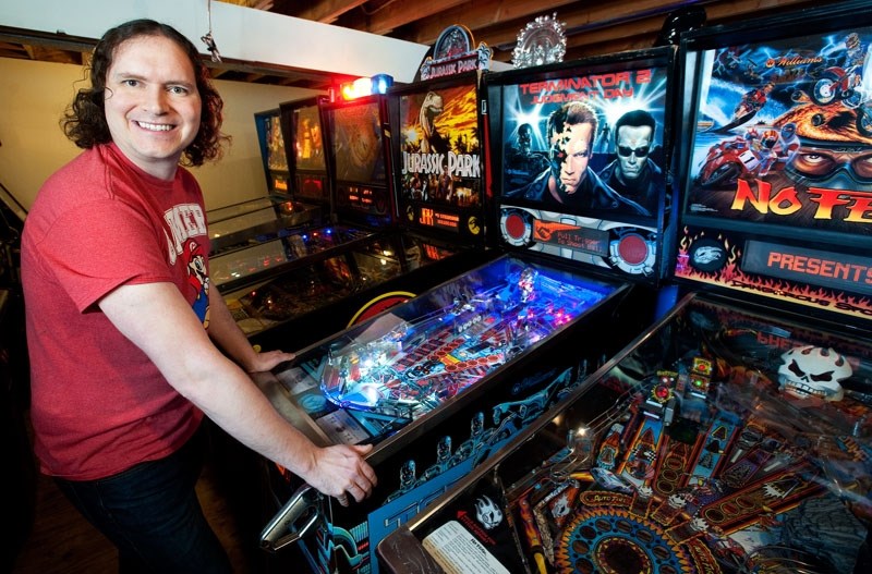 PINBALL WIZARDRY – Arcade collector Mathew Russell fires up a restored Terminator 2 pinball game in his basement in Strathcona County. Russell has collected some 98 pinball