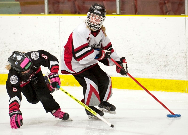 PLAYMAKER â€“ Makayla Topilko of the St. Albert Surge looks for an open teammate as Mackenzie Hewitt of Calgary Northwest Voltage loses an edge at the U12B provincials at