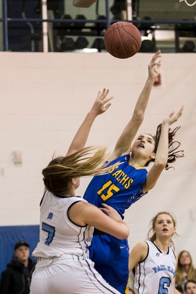 ONE-ON-ONE – Bronwen Barter of the Paul Kane Blues attempts to block a shot by Sarah Dedrick of the St. Albert Skyhawks during a metro Edmonton division one tilt Dec. 19 at