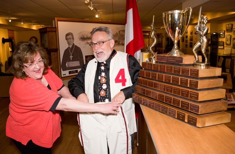 STILL FITS! — North Central Alberta Baseball League commissioner Paul Riopel shares a laugh with Musée Morinville Museum co-ordinator Donna Garrett as he tries on his