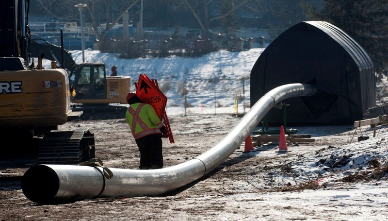A construction worker walks past Project 9 pipeline at a site north of the Sturgeon River and east of St. Albert Trail in St. Albert earlier this month. Transit users at St.