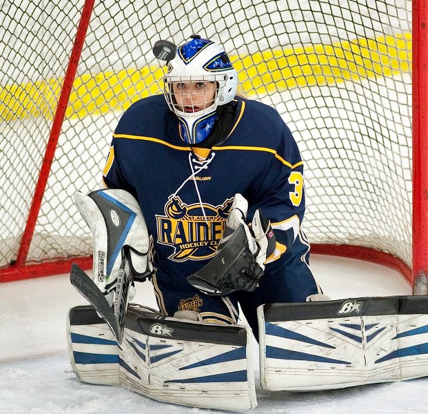 WIDE-EYED – St. Albert Slash netminder Brianna Sank stares down the puck during action in the Alberta Female Hockey League. The midget AAA provincial champions are hosting