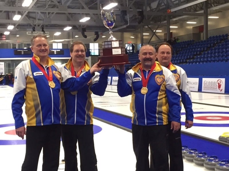 CANADIAN CHAMPS – The Wade White rink hoist the championship trophy in celebration after winning the senior (50-plus) nationals in Fredericton