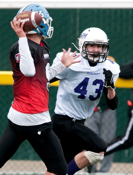 RUSHING THE THROWER â€“ Bronson Wilke of the St. Albert Storm zeroes in on Russell Dixon of the West Edmonton Raiders