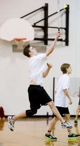 JUMP SHOT â€“ Taylor Huls of the Bellerose Bulldogs strikes the shuttle as teammate