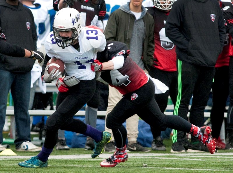 STORM CATCHER â€“ Michael Humen of West Edmonton Raiders wraps up the St. Albert Storm&#8217;s Logan McCullough from behind in the April 1 midget spring league football game. 