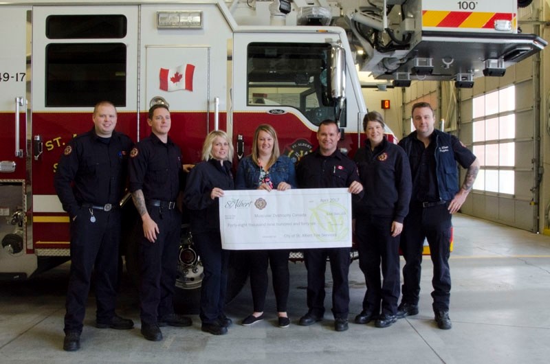 St. Albert Fire Services presents a cheque for $48