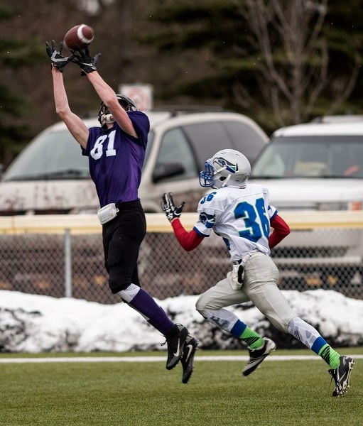 CATCH OF THE DAY â€“ Travis Heggart reels in a 33-yard touchdown pass behind Carlos Estrada of the Edmonton Seahawks in Saturday&#8217;s midget spring league game at the