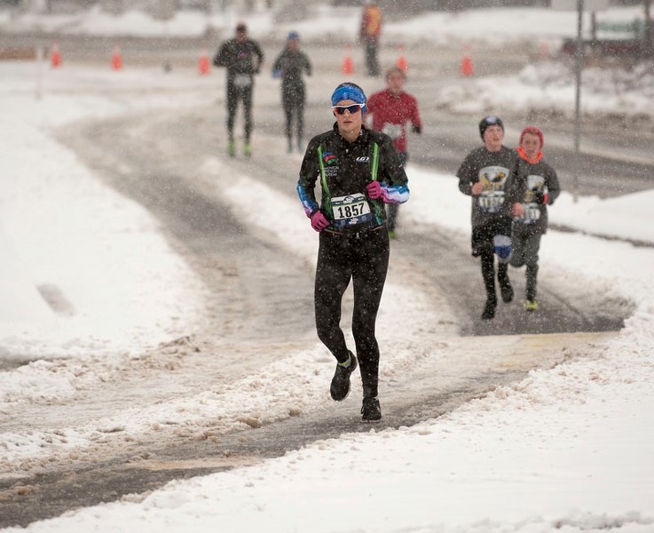 FOLLOWING THE TRAIL – Kathryn Oakey-Ayroud leads a group of five-kilometre runners through a winding and slushy St. Anne Street