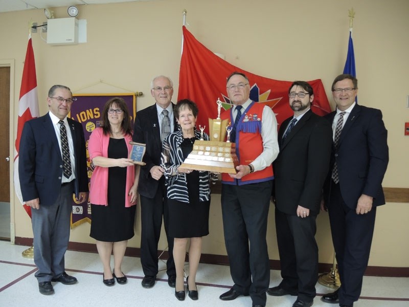 Carol Kaup accepts the Morinville Lions Club Citizen of the Year award. From left to right: Sturgeon County Mayor Tom Flynn; Morinville Lions Club President Deborah