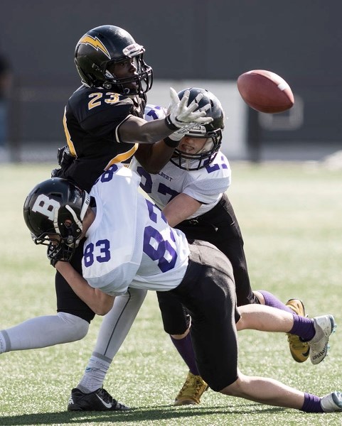 INCOMPLETION â€“ Marc Leblanc (83) and Kolby Phillips of the St. Albert Storm force Emmanuel Loggale to drop a pass during Saturday&#8217;s midget spring league game against