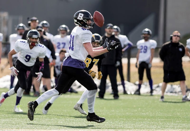 JUGGLING ACT â€“ Travis Heggart momentarily bobbles the ball before catching it and running into the endzone against the Edmonton Chargers in the midget spring league.