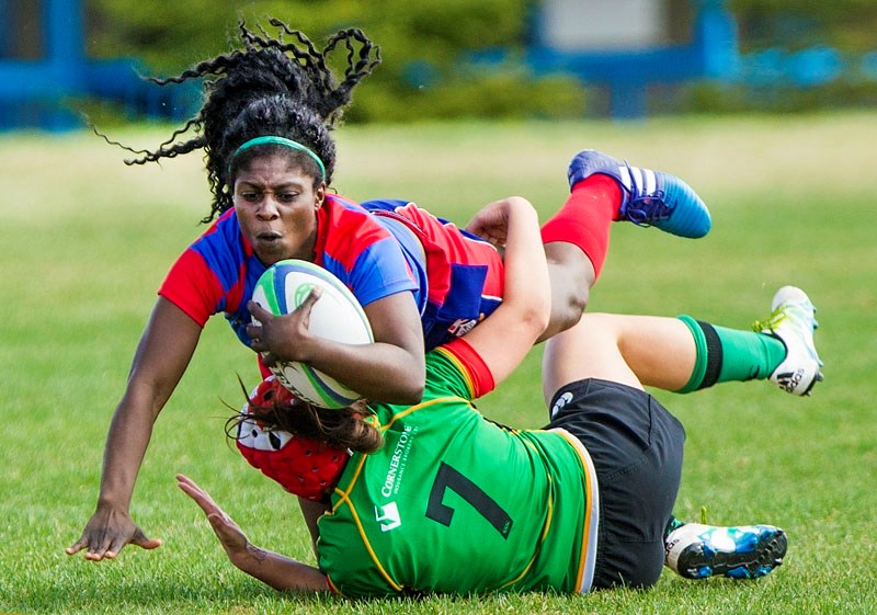 OVER THE TOP – Marcia Davis dives over a tackler in the season-opening Alberta Premier Women&#8217;s match against the Lep/Tigers on Saturday at the St. Albert Rugby Football 