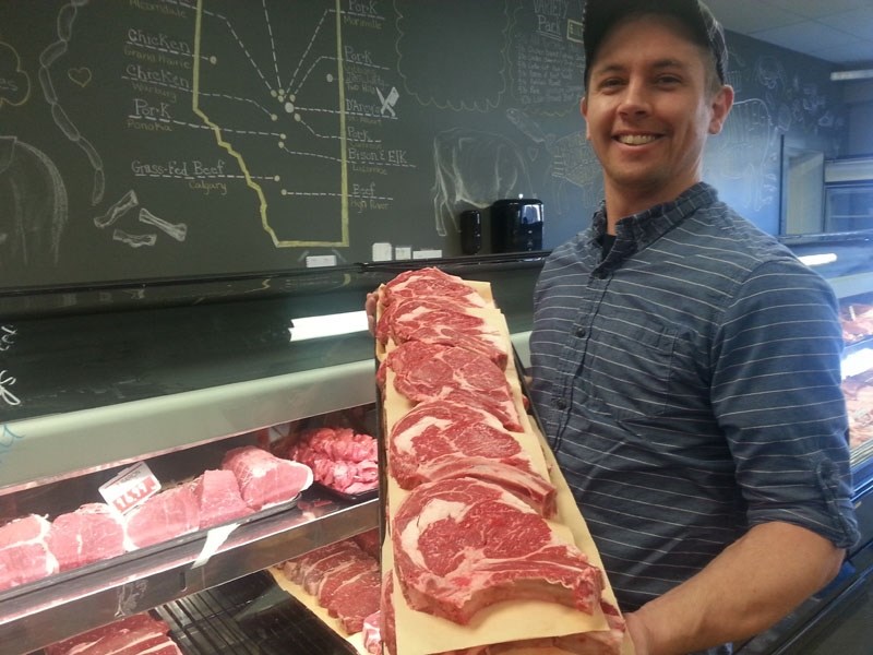 Kyle Iseke of D&#8217;Arcy&#8217;s Meats displays some fresh meat. Specialty shops offer consumers a farmers&#8217; market-style experience with a focus on fresh