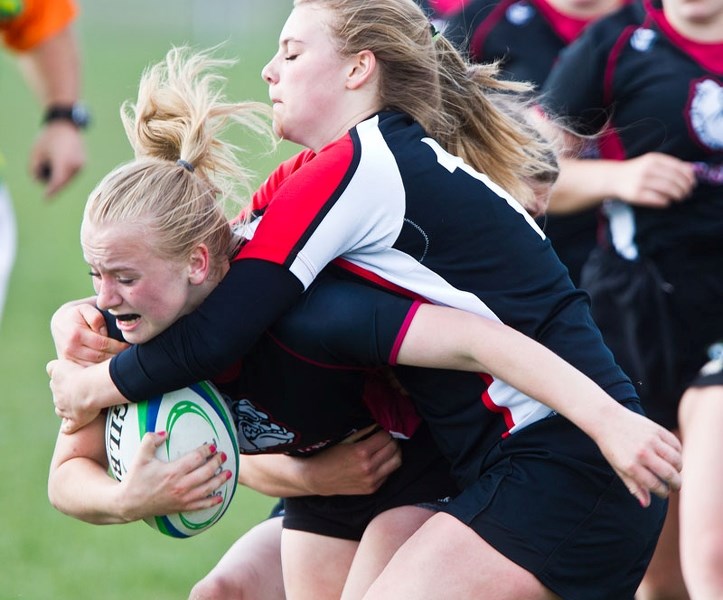 COLLARED – The Jasper Place Rebels struggle to stop Brooklyn Siewert of the Bellerose Bulldogs in Wednesday&#8217;s metro Edmonton division one match. The Bulldogs beat the