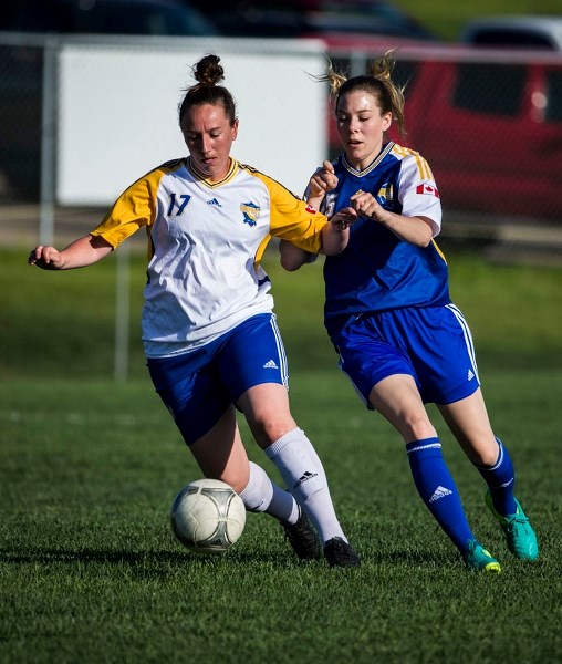 IMPACT CHALLENGE â€“ Players from the St. Albert Impact Premier and St. Albert Impact 1 teams jostle for the ball during Tuesday&#8217;s premier division match in the