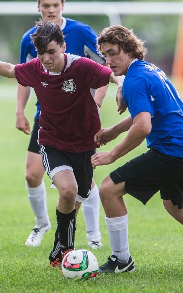 PLAYOFF CLASH – Stathis Pananos of the Bellerose Bulldogs and Josh Antunes of the St. Albert Skyhawks battle for ball possession