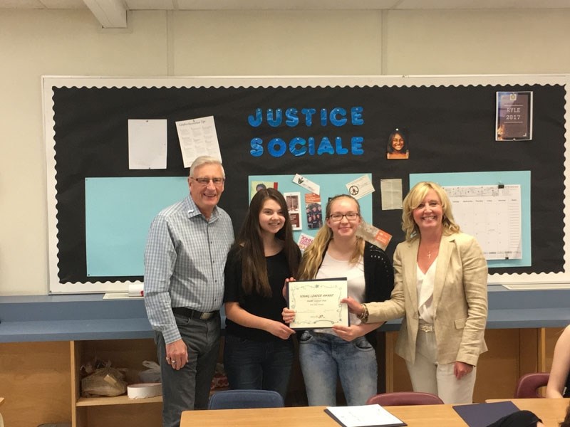 Rotary Club of St. Albert member Doug Campbell offers three District Youth Services Awards to ESSMY students Kasmira Warawa