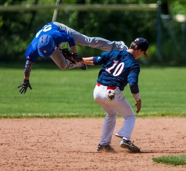 FLIPPING OUT â€“ An acrobatic Dawson Elliott of the Prairie Lights tries to avoid the tag from shortstop Zach Froment of the St. Albert Cardinals in Sunday&#8217;s Norwest