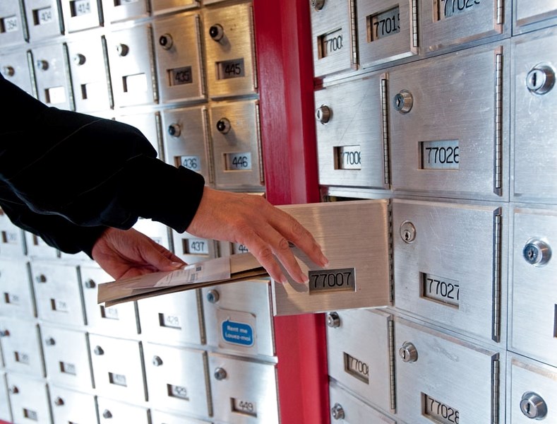 A person gets mail from her box at the Canada Post office on Perron Street in St. Albert. The postal union is asking city council to support a return to home mail delivery.