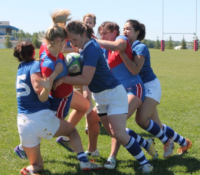 GANGED UP &#8211; Carys Williams maintains possession as the Pirates swarm the St. Albert player for the ball during the Alberta women&#8217;s premier match Saturday at the