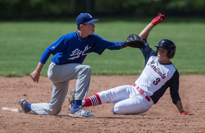 FEET FIRST &#8211; Dustyn Pankiw of the St. Albert Cardinals slides into a base against the Prairie Lights of Grande Prairie in the Norwest Midget AAA Baseball League. The